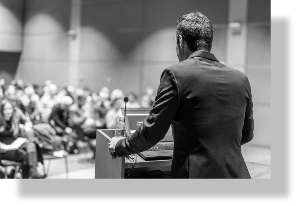 Speaker delivering semninar in black and white.